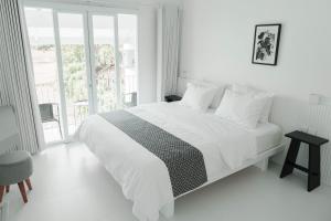a white bedroom with a large bed and a window at Villa IKIN Ubud in Ubud +46 photos