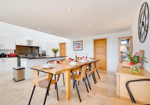 a kitchen and dining room with a wooden table and chairs at Wans Barton in Chickerell