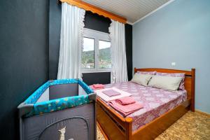 a small bedroom with a bed with a window at Elia Villa Thassos in Prinos