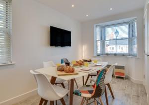 a dining room with a table with a plate of food on it at Marina View Townhouse in Weymouth