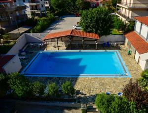 Draufsicht auf ein Schwimmbecken mit Sonnenschirm in der Unterkunft Hotel Edelweiss in Kalambaka