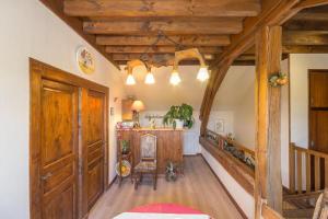 a hallway with wooden ceilings and a room with a table at Au Logis des Hirondelles 
