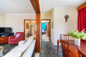 a living room with a couch and a table at Elia Villa Thassos in Prinos