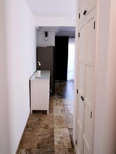 a hallway with a white door and a tile floor at Cosy, new studio in Costa Adeje in Adeje
