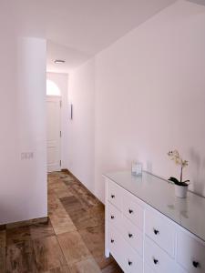 a white kitchen with a dresser in a room at Cosy, new studio in Costa Adeje in Adeje