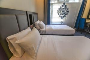 מיטה או מיטות בחדר ב-Kallisto Hotel
