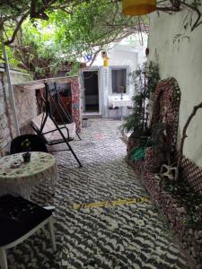 a patio with a table and a table and a building at LAVİNYA PENSİON in Kuşadası