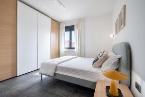 a small bedroom with a bed and a window at The Park View Place in Olbia