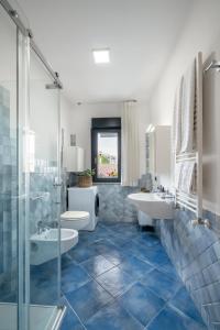 a bathroom with two sinks and a shower at The Park View Place in Olbia