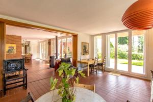 a living room with a fireplace and a table at Catalunya Casas Rural charm on an olive farm in Costa Dorada! in Vespellá