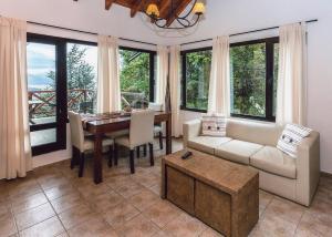 a living room with a couch and a table at Catalonia Sur Aparts-Spa in San Carlos de Bariloche