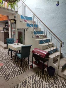 a table and chairs with a table and stairs at LAVİNYA PENSİON in Kusadası