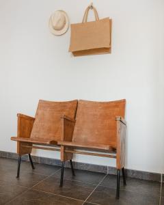 a wooden bench with a hat hanging on a wall at The Park View Place in Olbia