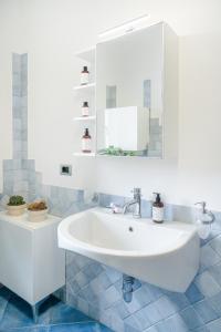 a bathroom with a white sink and a mirror at The Park View Place in Olbia