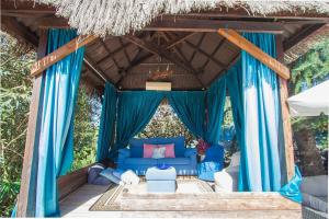 a living room with a blue couch and blue curtains at Catalunya Casas An oasis for up to 26 nature loving guests! in Sils