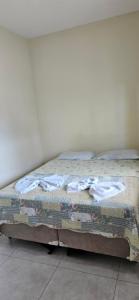 a bed sitting in a room with at Pousada Viva Mar in Saquarema