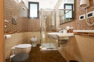 a bathroom with a toilet and a sink and a shower at Bed&Belvedere in Otranto