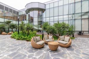 a group of chairs sitting in front of a building at Hotel de Convenções de Talatona, HCTA in Luanda