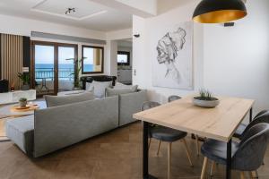 a living room with a couch and a table at Mare Apartment Costal Gem in Gázion
