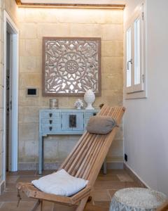 a wooden bench in a room with a blue desk at Masseria dei Monaci in Otranto