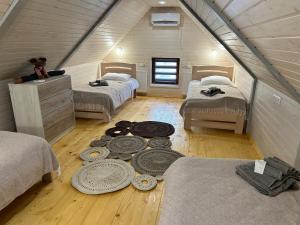 a attic bedroom with two beds and a wooden floor at Апартаменти Гармонія in Mizhhirya