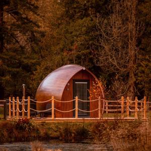 a small wooden dome house with a wooden fence at The Secret Hideaway in Penicuik