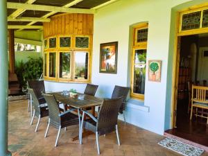 a dining room with a wooden table and chairs at Bonnie Highlands in Ladysmith