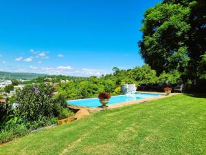 a swimming pool in a yard with a grass field at Bonnie Highlands in Ladysmith