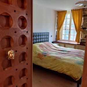 Postel nebo postele na pokoji v ubytování Le vieux moulin