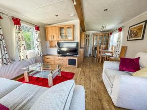 a living room with two couches and a tv at 6 Berth Caravan With Decking At Cherry Tree Park In Norfolk Ref 70014g in Great Yarmouth