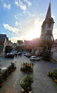 a town with cars parked in a parking lot with a church at La maison père camembert in Honfleur