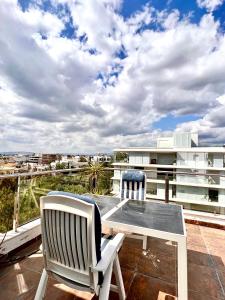 a patio with two chairs and a table on a balcony at CityCenter Penthouse mini Private Pool with Hydromassage and Great Town View in Athens