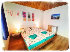 a bedroom with a bed and a wooden floor at Haus Grubbach in Spital am Pyhrn