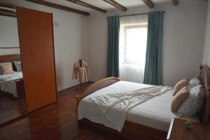 a bedroom with a bed and a window at Villa Carla - Istrian house in Koper