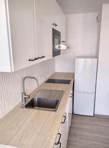 La cuisine est équipée d'un évier et d'un réfrigérateur. dans l'établissement Résidence Graziella Appartement 510, à Juan-les-Pins