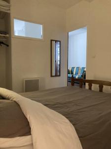 a bedroom with a large bed and a couch at Apartment Centre Historic in Marvejols