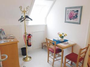a kitchen with a table and chairs and aburning at Ferienwohnung Harms in Garlstorf +10 photos