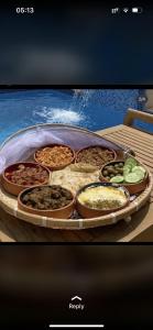 a tray of different types of food on a table at Beach front Le Bon villa in Muscat