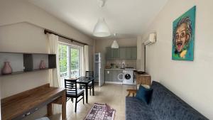 a living room with a couch and a dining room at Kemer Comfort Apartment 01 in Kemer