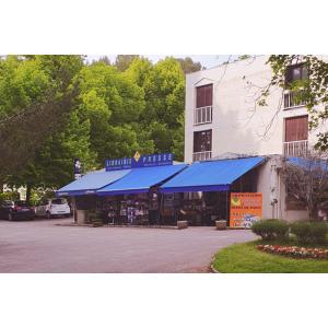 a building with a blue canopy in a parking lot at Parc paradis in Gréoux-les-Bains