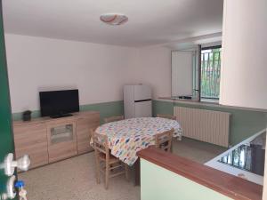 a small kitchen with a table and a television in a room at Casa Venezia in Senigallia