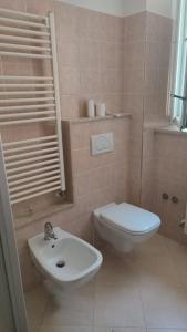 a bathroom with a toilet and a sink at Casa Venezia in Senigallia +7 photos