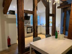 a kitchen with a table and a kitchen with wooden beams at Wassermühle Habighorst in Habighorst