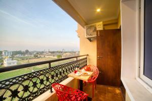a balcony with a table and chairs and a view at SM Royal Stay Hotel - Near Bangalore international Airport in Bangalore