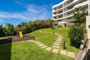 a playground in front of a apartment building at Calheta Victory View by An Island Apart in Calheta
