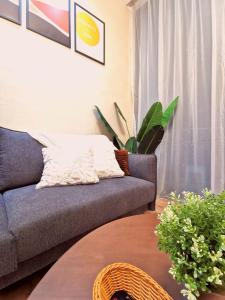 a living room with a couch and a table at Stylish Micasa 4 Home 3BR+FREE PARKING -Hann's Residence in Sibu