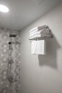 a bunch of towels on a towel rack in a bathroom at "Panorama" Kakhri in Mestia