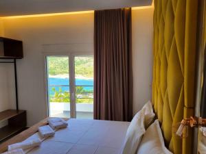 a bedroom with a bed with a view of the ocean at Vila Bello in Ksamil