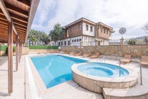 a swimming pool in front of a house at Olinda Hotel & Spa in Şile