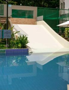 a swimming pool with a slide in the water at Park veredas Rio Quente Flavia in Rio Quente +12 photos